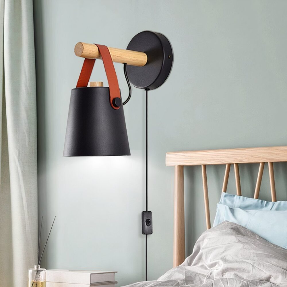 Aplique de pared con cable de estilo nórdico y pantalla negra montado en la pared de un dormitorio