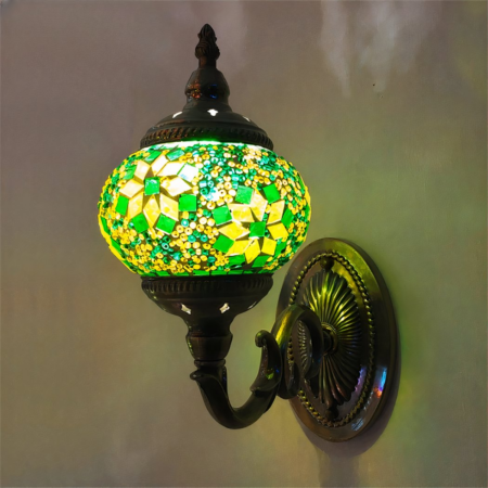 Un aplique floral oriental verde y amarillo fijado a una pared